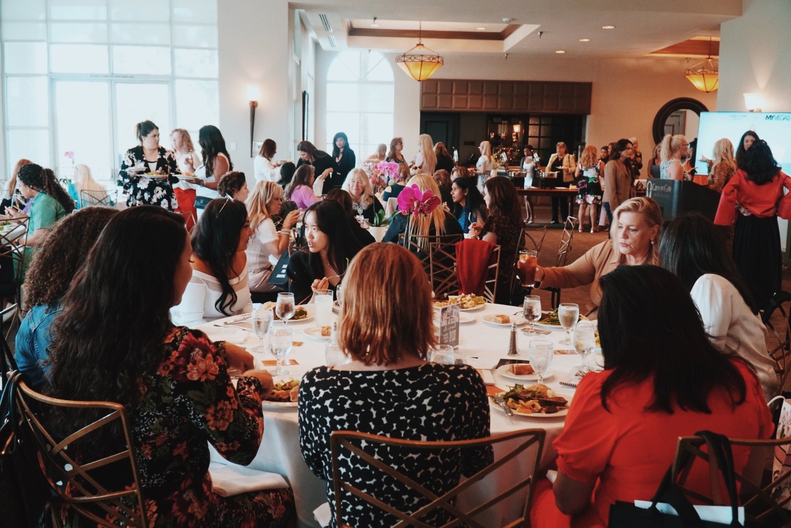 Women gathered in an OWN IT event room for inspiration and leadership